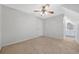 Cozy bedroom with neutral carpet, ceiling fan, and adjacent bathroom at 2051 E Piedmont Rd, Marietta, GA 30062