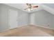 Spacious bedroom with neutral carpet, ceiling fan, and multiple doors, providing comfort and convenient access at 2051 E Piedmont Rd, Marietta, GA 30062