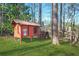 A chicken coop surrounded by green grass with a sign that says Fresh Eggs at 2051 E Piedmont Rd, Marietta, GA 30062