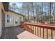 Back deck with stairs leading to lawn and surrounding trees under a bright sky at 2051 E Piedmont Rd, Marietta, GA 30062