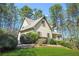 Home featuring a lush lawn with mature trees and shrubs at 2051 E Piedmont Rd, Marietta, GA 30062