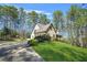 Inviting home with a well-manicured lawn, beautiful landscaping, and mature trees in a serene setting at 2051 E Piedmont Rd, Marietta, GA 30062
