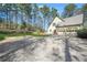 Home featuring an attached two-car garage, green lawn, and mature trees at 2051 E Piedmont Rd, Marietta, GA 30062