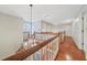 Elegant landing with hardwood floors, chandelier, and a white railing, creating a bright, transitional space at 2051 E Piedmont Rd, Marietta, GA 30062