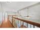 Well-lit landing with hardwood floors, decorative lighting, and a white railing, offering a bright transition at 2051 E Piedmont Rd, Marietta, GA 30062