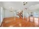 Bright living room with wood floors, vaulted ceiling, and staircase at 2051 E Piedmont Rd, Marietta, GA 30062
