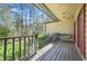Cozy covered porch with a hanging swing and views of the surrounding trees at 2051 E Piedmont Rd, Marietta, GA 30062