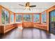 Inviting sunroom with wood paneling, built-in shelving, and large windows offering scenic views at 2051 E Piedmont Rd, Marietta, GA 30062