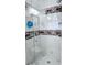 Bathroom walk-in shower featuring stylish, decorative tiling, and glass doors at 3007 Hidden Dr, Lawrenceville, GA 30044
