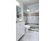 Bathroom featuring a tiled shower with glass doors, decorative tiles, and a white vanity at 3007 Hidden Dr, Lawrenceville, GA 30044