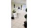 Bathroom features a stand alone sink, commode, large mirror and decorative plants at 3007 Hidden Dr, Lawrenceville, GA 30044