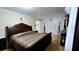 Bedroom boasts a large bed with detailed wood frame, hardwood floors, and a rocking chair at 3007 Hidden Dr, Lawrenceville, GA 30044