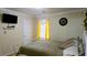 Bedroom with a TV, clock, decorative metal bed frame and bright yellow curtains at 3007 Hidden Dr, Lawrenceville, GA 30044