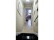 Hallway has tile flooring and decorative art leading to a living room view at 3007 Hidden Dr, Lawrenceville, GA 30044