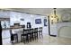 Bright, open kitchen featuring white cabinetry, a central island with seating, and modern appliances at 3007 Hidden Dr, Lawrenceville, GA 30044