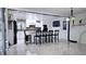Modern kitchen with white cabinetry, granite countertops, a central island, and tile flooring at 3007 Hidden Dr, Lawrenceville, GA 30044