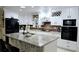 Island kitchen featuring granite countertops, white cabinets, a modern appliance package, and tile flooring at 3007 Hidden Dr, Lawrenceville, GA 30044