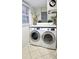 Laundry room featuring a modern washer and dryer set with a bright window view at 3007 Hidden Dr, Lawrenceville, GA 30044