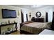 Comfortable main bedroom featuring a plush bed, dark wood furniture, and decorative accents at 3007 Hidden Dr, Lawrenceville, GA 30044