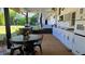 Covered outdoor kitchen complete with sink, cabinetry, and cooktop at 3007 Hidden Dr, Lawrenceville, GA 30044