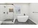 Bathroom featuring a soaking tub and glass enclosed shower with white marble tile at 793 Joseph E Boone Nw Blvd, Atlanta, GA 30314