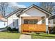 Charming home with a cozy front porch and modern wooden slats for added privacy and curb appeal at 793 Joseph E Boone Nw Blvd, Atlanta, GA 30314