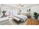 Bright main bedroom with a ceiling fan, light walls, and french doors to the deck at 793 Joseph E Boone Nw Blvd, Atlanta, GA 30314