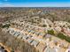 An aerial view displays the residential neighborhood with houses and a distant lake at 1913 Shenley Park Ln, Duluth, GA 30097