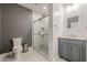 Modern bathroom with white marble floors and gray walls and a glass door shower stall at 1913 Shenley Park Ln, Duluth, GA 30097