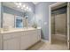 Bathroom featuring double sink vanity, large mirror, and walk-in shower with sliding glass doors at 1913 Shenley Park Ln, Duluth, GA 30097