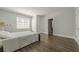 Neutral bedroom with a light-colored comforter, window, and dark hardwood flooring at 1913 Shenley Park Ln, Duluth, GA 30097