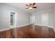 Large bedroom featuring dark hardwood floors, ceiling fan, and ensuite bathroom access at 1913 Shenley Park Ln, Duluth, GA 30097