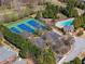 Aerial view of community tennis courts, pool, clubhouse, and parking at 1913 Shenley Park Ln, Duluth, GA 30097