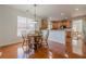 Dining area with wood floors, a round table and a view into kitchen with breakfast bar at 1913 Shenley Park Ln, Duluth, GA 30097