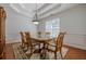 Bright dining room featuring hardwood floors, elegant lighting, and detailed trim at 1913 Shenley Park Ln, Duluth, GA 30097