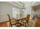 Bright dining room featuring hardwood floors, elegant lighting, and detailed trim at 1913 Shenley Park Ln, Duluth, GA 30097