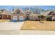 Charming one-story brick home featuring a two-car garage and well-manicured front lawn at 1913 Shenley Park Ln, Duluth, GA 30097