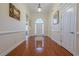 Inviting foyer with hardwood floors, arched doorway, and decorative lighting at 1913 Shenley Park Ln, Duluth, GA 30097