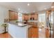 Open kitchen with breakfast bar, wood cabinets, and stainless steel appliances adjacent to dining area at 1913 Shenley Park Ln, Duluth, GA 30097