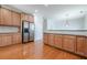 Bright kitchen showcasing stainless steel refrigerator, wooden cabinets, and hardwood floors at 1913 Shenley Park Ln, Duluth, GA 30097