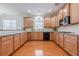 Spacious kitchen featuring wooden cabinets, hardwood floors, and modern appliances at 1913 Shenley Park Ln, Duluth, GA 30097