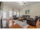 Spacious living room featuring hardwood floors, a fireplace, and built-in shelving at 1913 Shenley Park Ln, Duluth, GA 30097