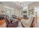 Spacious living room featuring hardwood floors, a fireplace, and built-in shelving at 1913 Shenley Park Ln, Duluth, GA 30097