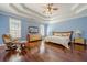 Main bedroom with wood floors, tray ceiling, sitting area and natural light at 1913 Shenley Park Ln, Duluth, GA 30097