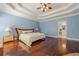 Large main bedroom offers tray ceilings, wood floors and ensuite bath at 1913 Shenley Park Ln, Duluth, GA 30097