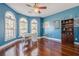 Bright office with arched windows, a modern desk setup, and a built-in bookcase at 1913 Shenley Park Ln, Duluth, GA 30097