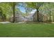 Expansive backyard featuring a well-maintained lawn and mature trees provides a serene outdoor space at 2000 Mcconnell Rd, Grayson, GA 30017