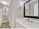 Well-lit bathroom featuring a vanity with sink, mirror, and organized shelving at 2000 Mcconnell Rd, Grayson, GA 30017