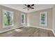 A spacious bedroom filled with natural light with wood-look floors and multiple windows at 2000 Mcconnell Rd, Grayson, GA 30017