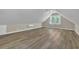 Finished bonus room features clean walls, a ceiling fan, and hardwood floors at 2000 Mcconnell Rd, Grayson, GA 30017